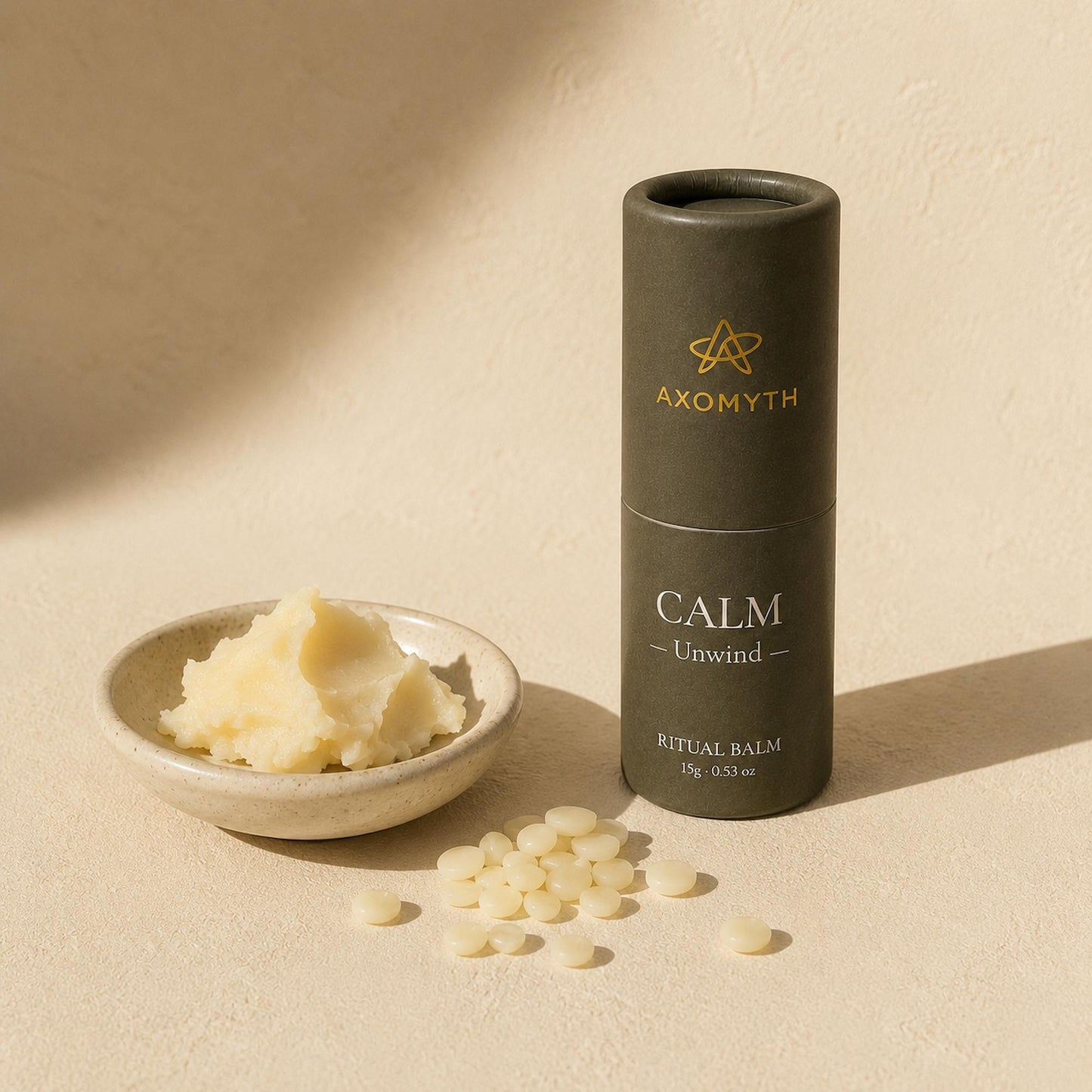Raw ingredients for AXOMYTH CALM — butter, wax pellets and the ritual balm tube