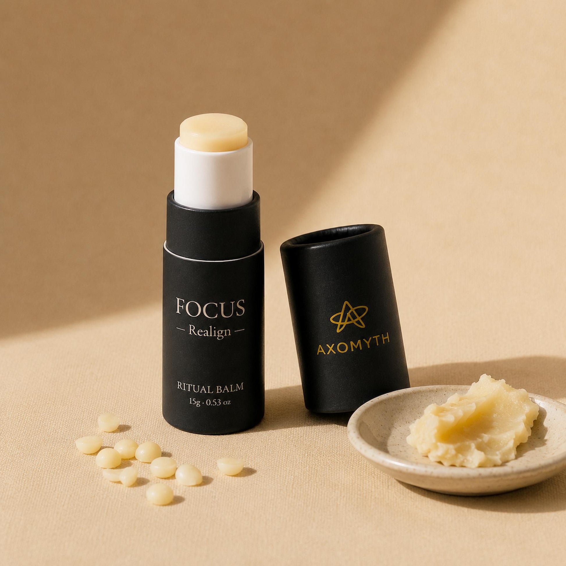 Raw ingredients for AXOMYTH FOCUS — butter, wax pellets and the ritual balm tube