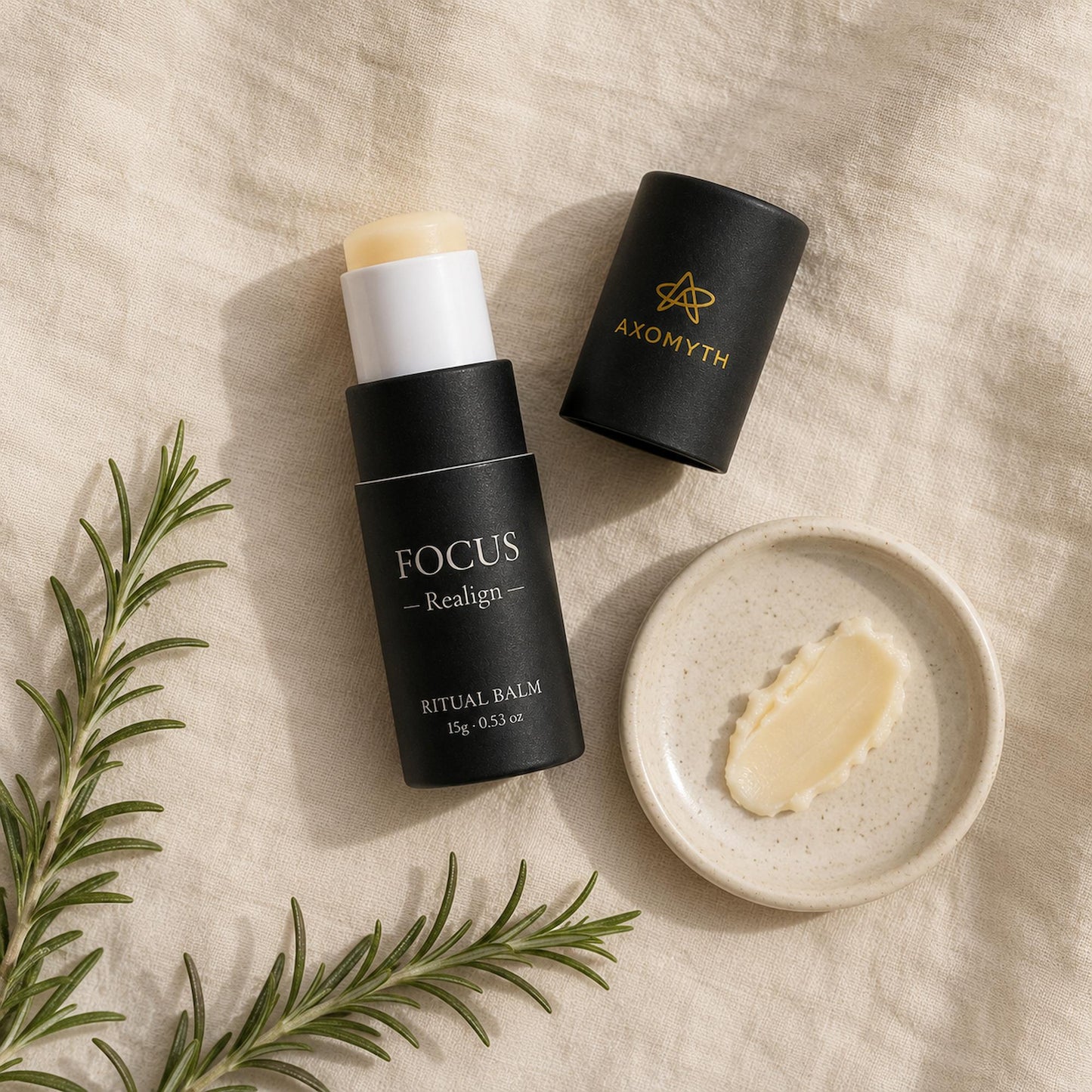 AXOMYTH FOCUS ritual balm flat lay with balm swatch, rosemary and linen