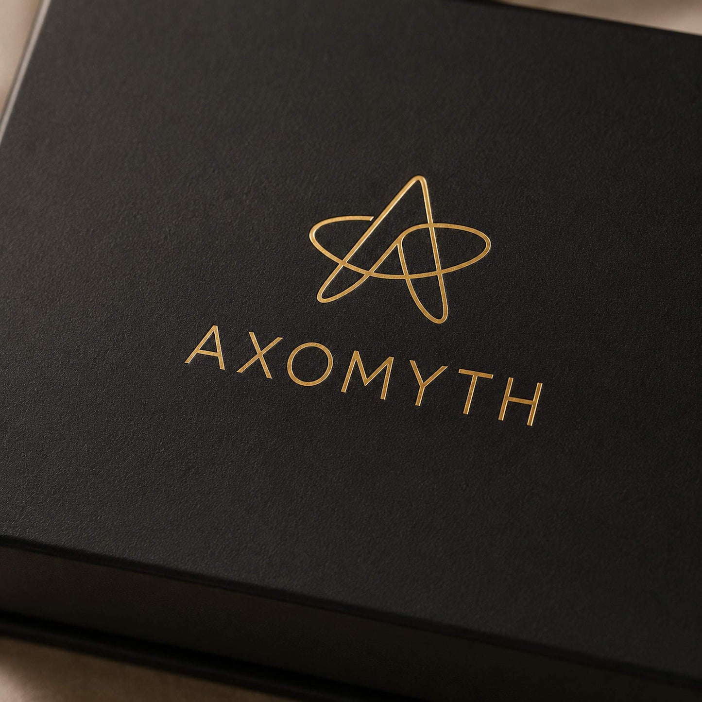 AXOMYTH gold foil logo detail on the Complete Ritual Set gift box