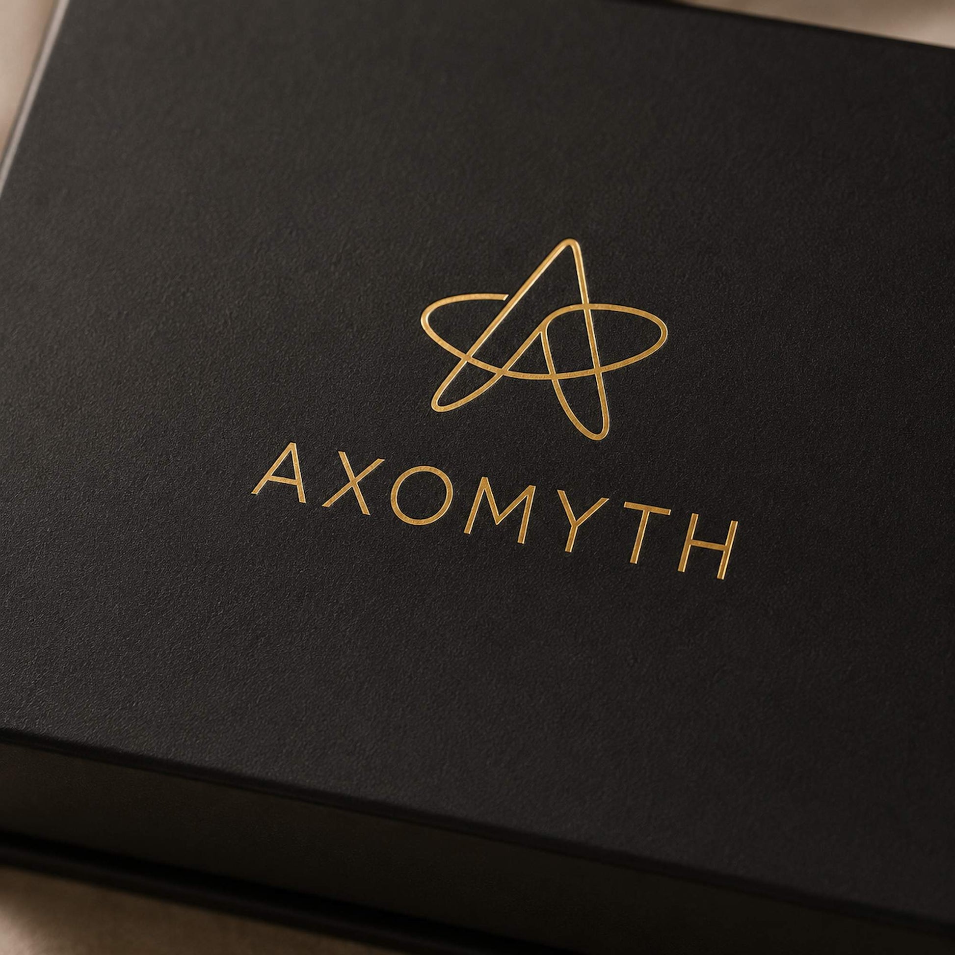 AXOMYTH gold foil logo detail on the Complete Ritual Set gift box