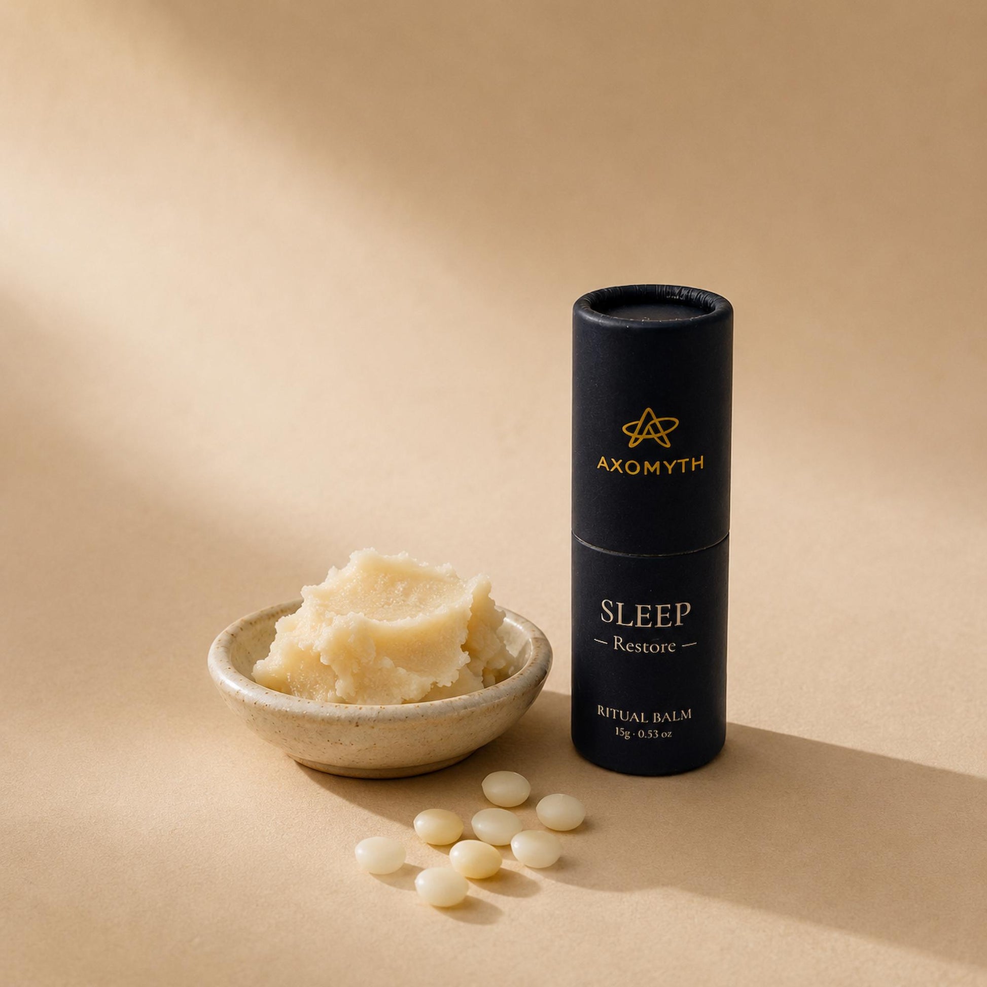 Raw ingredients for AXOMYTH SLEEP — butter, wax pellets and the ritual balm tube