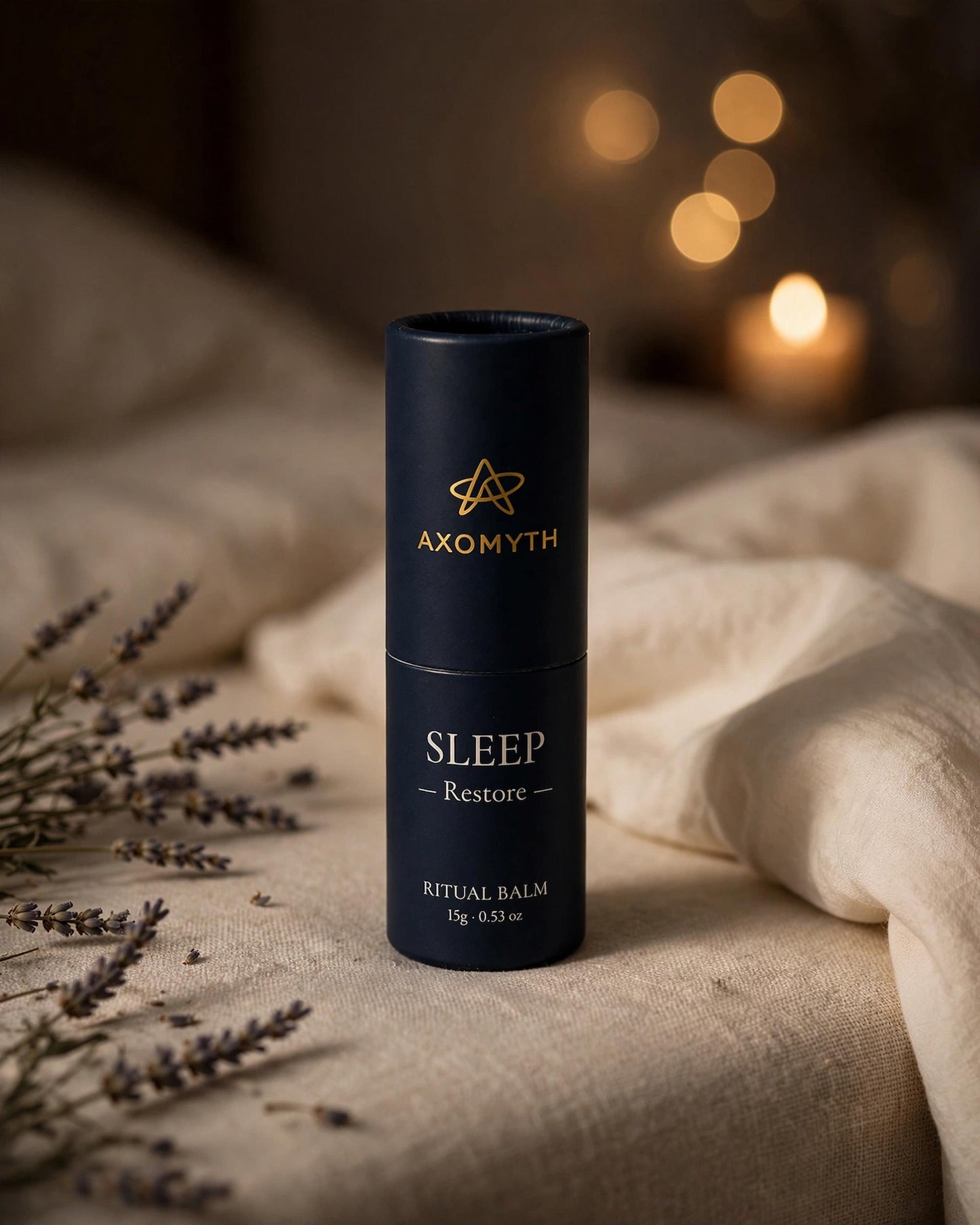 AXOMYTH SLEEP ritual balm on a nightstand with candlelight and dried lavender