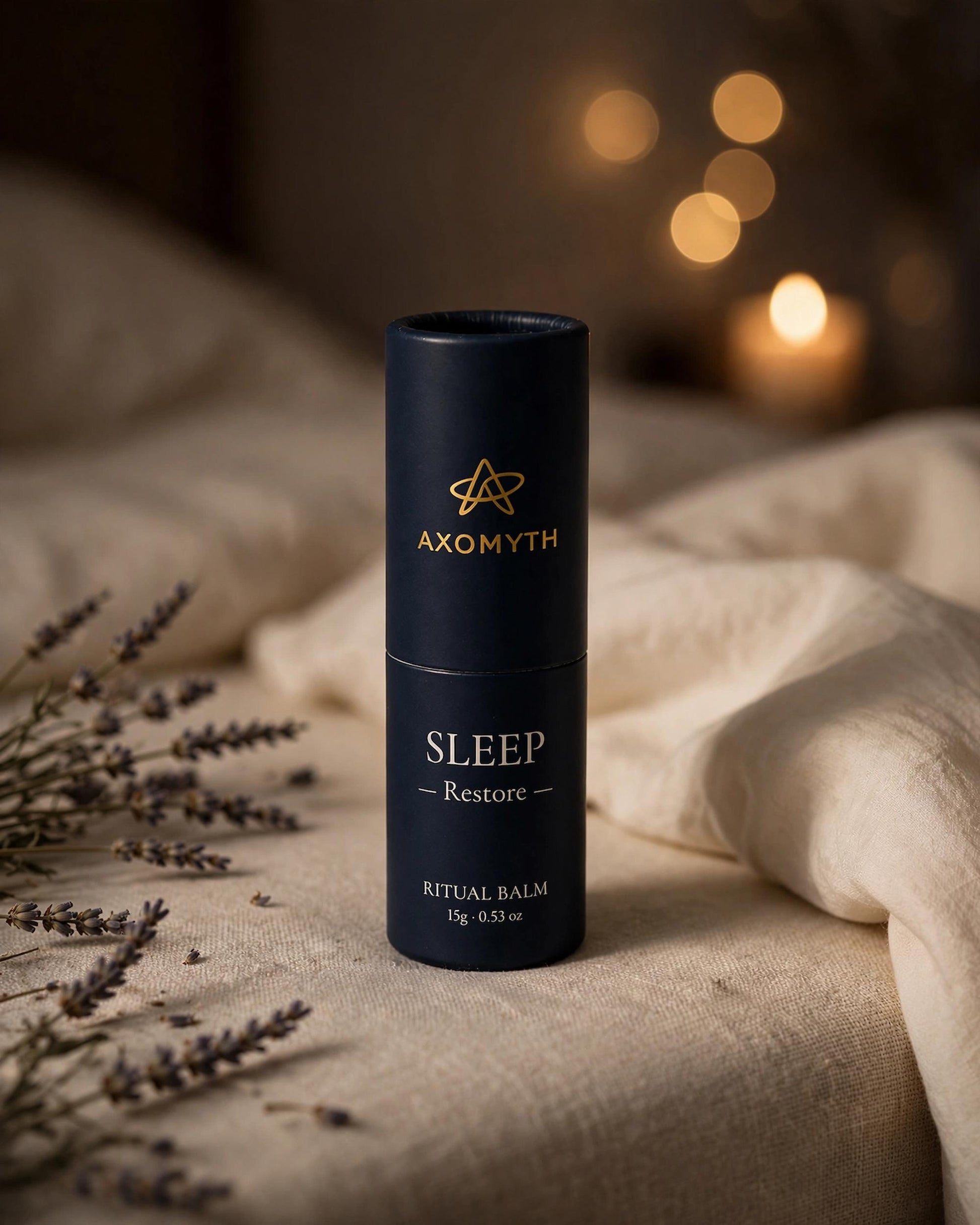 AXOMYTH SLEEP ritual balm on a nightstand with candlelight and dried lavender